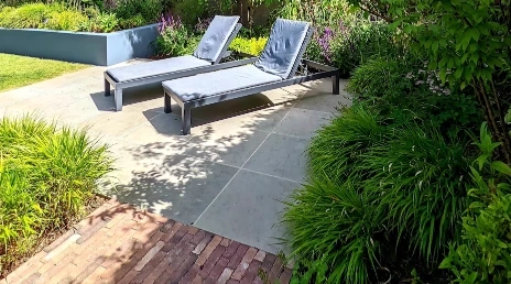 Paver patio with outdoor lounge chairs and planters for outdoor living in Las Cruces NM